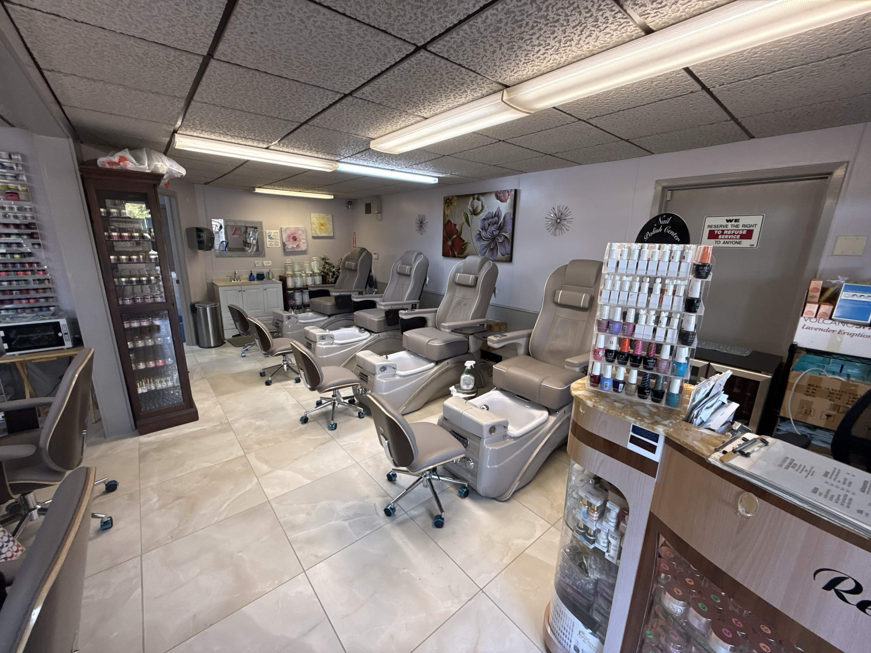 Pedicure chairs and nail polish color wall at Kim's Nail & Spa
